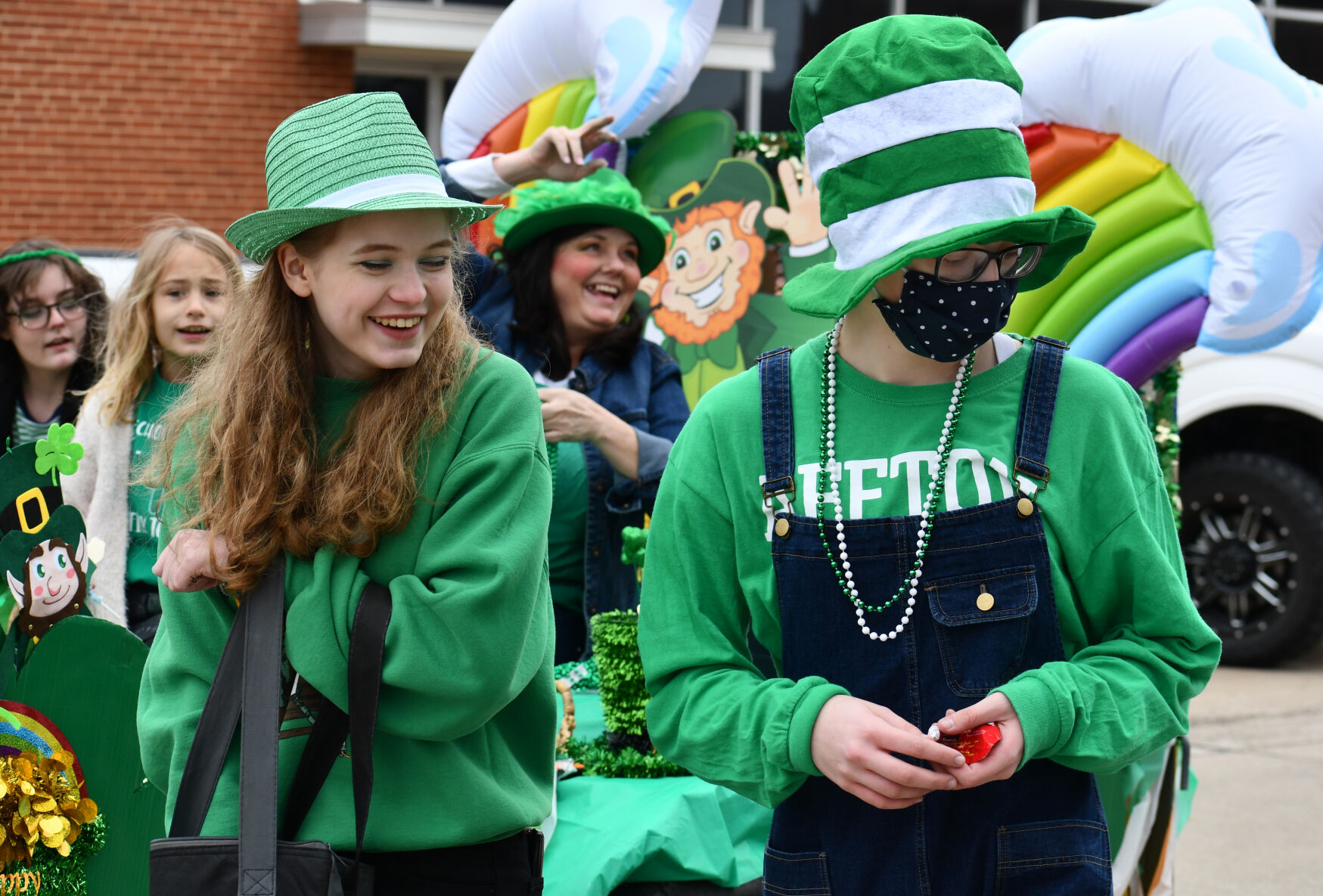 People toss beads and candy